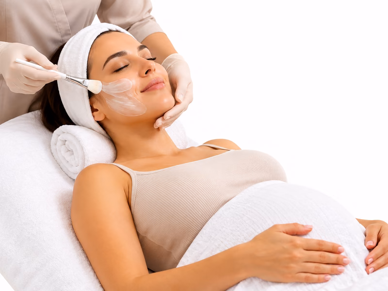 A pregnant client receiving a facial treatment